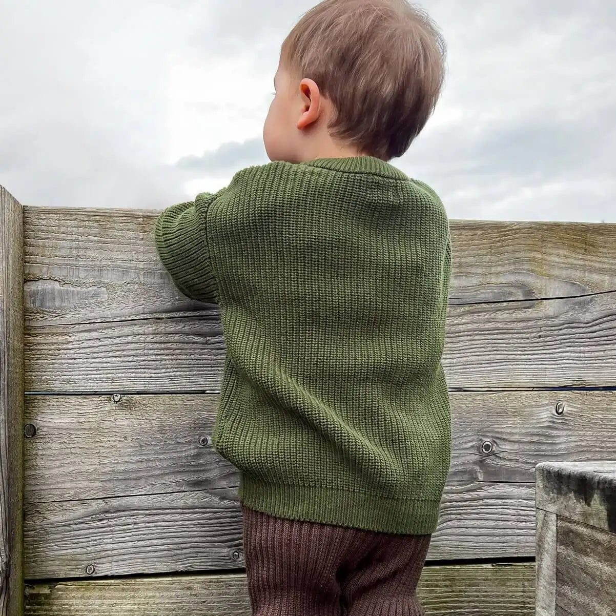 toddler in forest chunky crew knit jumper, great for mix & match styling and perfect for a fun-filled day outdoors
