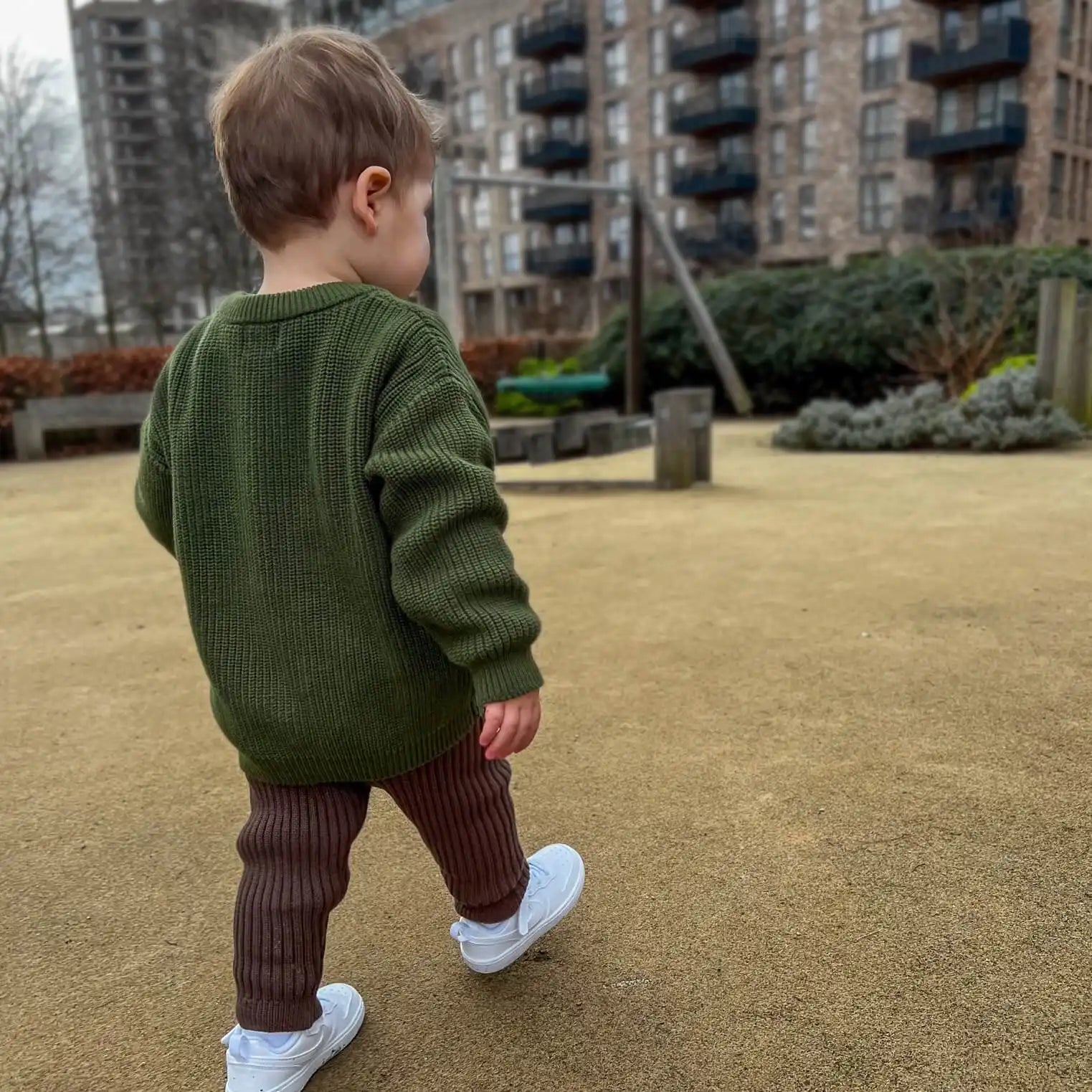 toddler wearing chunky crew knit jumper in forest and chunky knit leggings in cocoa, made with 100% organic cotton offering cozy style for chilly days