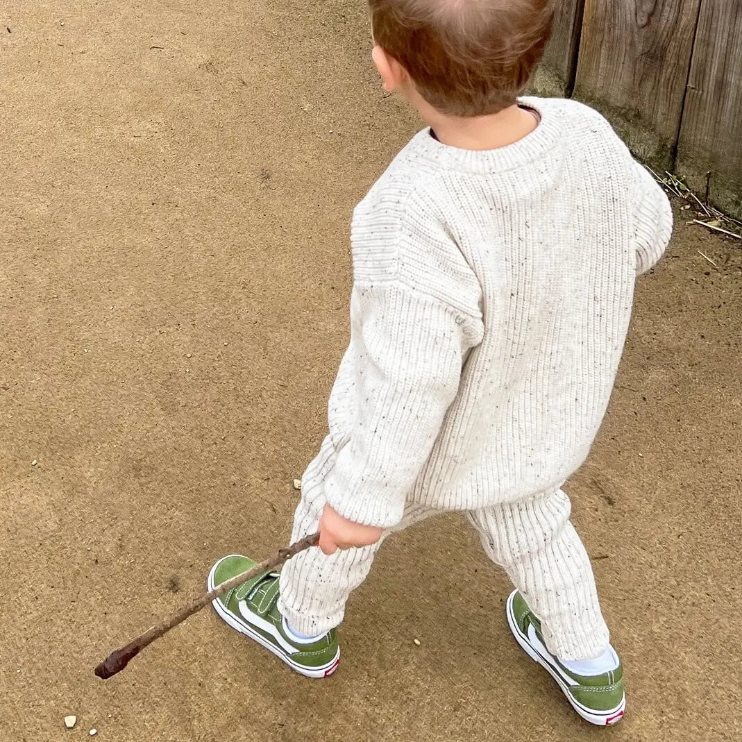 toddler wearing oversized chunky knit jumper in frosty speckle with matching leggings, stylish and cozy for a comfy day of play